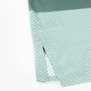 detail picture of the side splits of the ciele athletics lightweight, race ready and performance driven singlet named RDSinglet in turquoise color from the lifetime edition