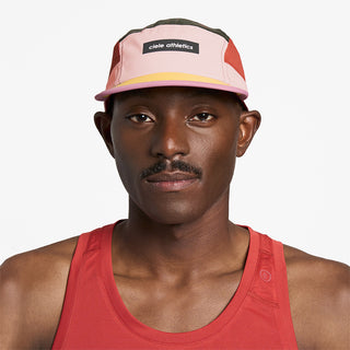 front view of ciele athletics GOCap Field Iconic Bar unisex running hat in peachskin seaweed color on a model
