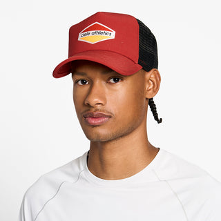 front view of the ciele athletics TRLCap unisex running hat with a curved brim in clay color, on a model