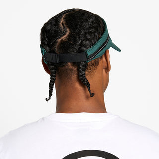 back view of the ciele athletics TRLCap unisex running visor with a curved brim in emerald color, on a model