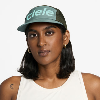 front view of the ciele athletics GOCap unisex running hat in silver pine color, on a model