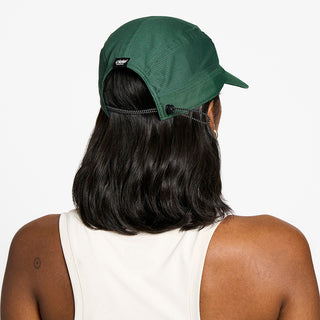 back view of the ciele athletics FTSCap unisex running hat with a curved brim in emerald color, on a model