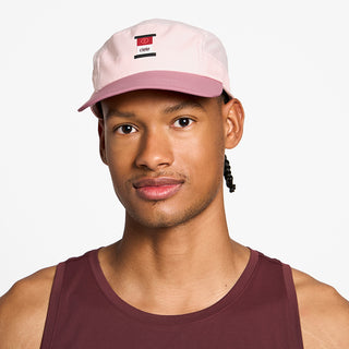 front view of the ciele athletics GOCap with a curved brim unisex running hat in peachskin color, on a model