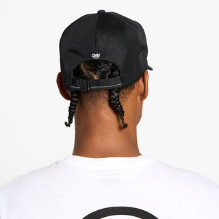 back view of the ciele athletics TRLCap unisex running hat with a curved brim in shadowcast color, on a model