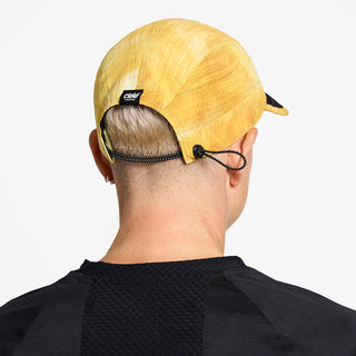 back view of ciele athletics FSTCap unisex running hat from the Elite collection in sphinx color, on a model
