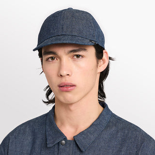 front view of ciele athletics CRWCap short brim unisex running hat with shorter brim from the Lifestyle Edition collection, in denim indigo color, on a model
