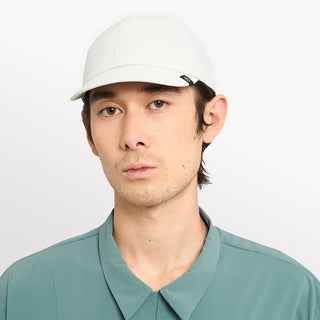 front view of ciele athletics CRWCap short brim unisex running hat with shorter brim from the Lifestyle Edition collection, in light grey color, on a model
