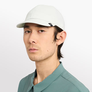 side view of ciele athletics CRWCap short brim unisex running hat with shorter brim from the Lifestyle Edition collection, in light grey color, on a model