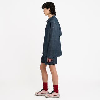 side view of ciele athletics CCJacket unisex running jacket from the Lifestyle Edition collection, in denim indigo color, when worn with the CCShort in Denim Indigo