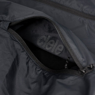 closeup view of the inside pocket logo of the ciele athletics VNTJacket lightweight running jacket for men in shadowcast color