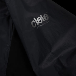 closeup view of the reflective sleeve logo of the ciele athletics VNTJacket lightweight running jacket for men in shadowcast color, when reflective