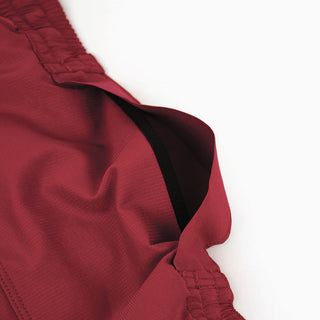 close view of the hidden back pocket of the ciele athletics TRNShort 7 inch linerless short in merlot color