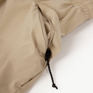 close view of the zippered side pocket of the ciele athletics ATShort 5 inch with liner short in safari color