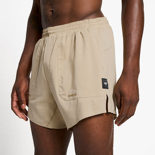 close front view of ciele athletics ATShort 5 inch with liner short in safari color on a model