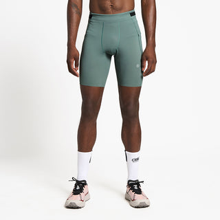 front view of ciele athletics FSTTight 8 inch short running tight in silver pine on a model