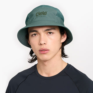 front view of ciele athletics GOBucket Comp Athletics unisex running bucket hat in silverpine color on a model