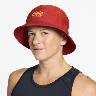 side view of ciele athletics GOBucket Comp Athletics unisex running buckethat in clay color on a model