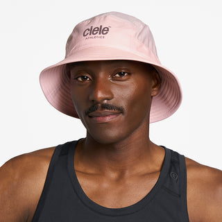 front view of ciele athletics GOBucket Comp Athletics unisex running bucket hat in peachskin color on a model