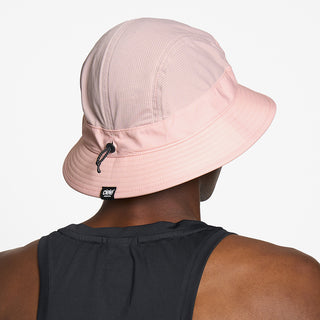 back view of ciele athletics GOBucket Comp Athletics unisex running bucket hat in peachskin color on a model