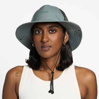 front view of the ciele athletics TRLBucket unisex running bucket hat in silver pine color, on a model