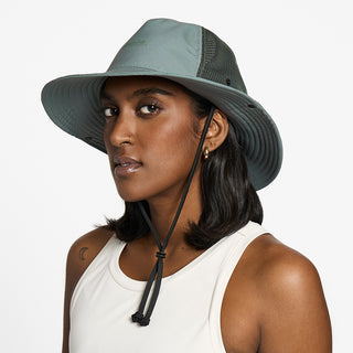 side view of the ciele athletics TRLBucket unisex running bucket hat in silver pine color, on a model