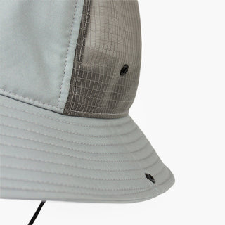 closeup view of the ciele athletics TRLBucket unisex running bucket hat side button closure in neutral grey color