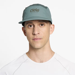 front view of ciele athletics GOCap unisex running hat in silver pine color on a model