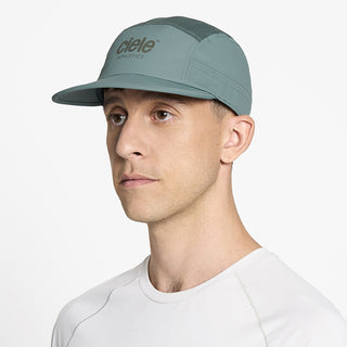 side view of ciele athletics GOCap unisex running hat in silver pine color on a model