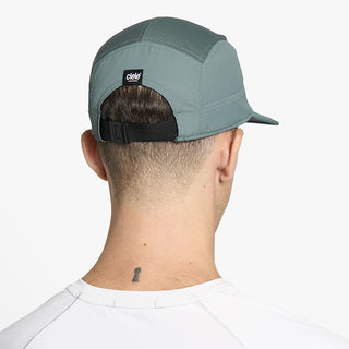 back view of ciele athletics GOCap unisex running hat in silver pine color on a model