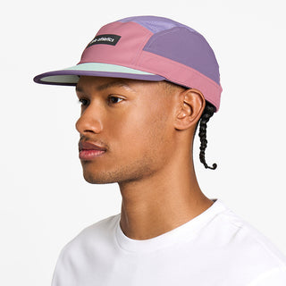 side view of the ciele athletics GOCap unisex running hat in deco rose color, on a model