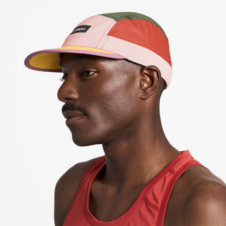 side view of ciele athletics GOCap Field Iconic Bar unisex running hat in peachskin seaweed color on a model