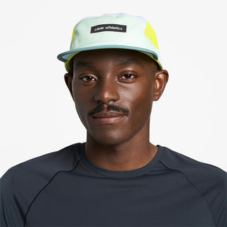 front view of ciele athletics GOCap Field Iconic Bar unisex running hat in dusty turquoise white color on a model