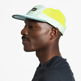 side view of ciele athletics GOCap Field Iconic Bar unisex running hat in dusty turquoise white color on a model