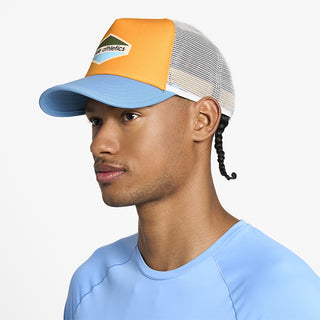 side view of ciele athletics TRLCap SC Field Updown unisex running hat in clementine color on a model