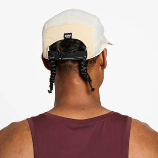 back view of the ciele athletics GOCap unisex running hat in safari color, on a model