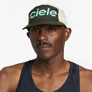 front view of ciele athletics GOCap Comp Century unisex running hat in seaweed rainy day color on a model