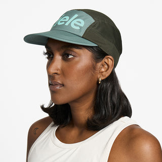side view of the ciele athletics GOCap unisex running hat in silver pine color, on a model