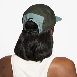 back view of the ciele athletics GOCap unisex running hat in silver pine color, on a model