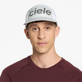 front view of ciele athletics GOCap Comp Century unisex running hat in lightgrey white color on a model