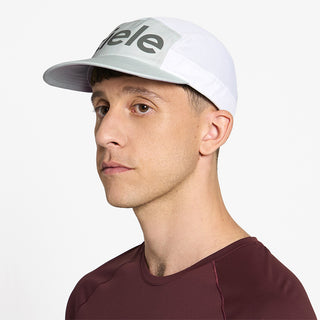 side view of ciele athletics GOCap Comp Century unisex running hat in lightgrey white color on a model