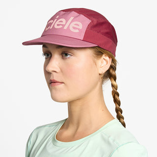 side view of ciele athletics GOCap Comp Century unisex running hat in deco rose merlot color on a model