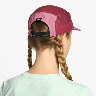 back view of ciele athletics GOCap Comp Century unisex running hat in deco rose merlot color on a model