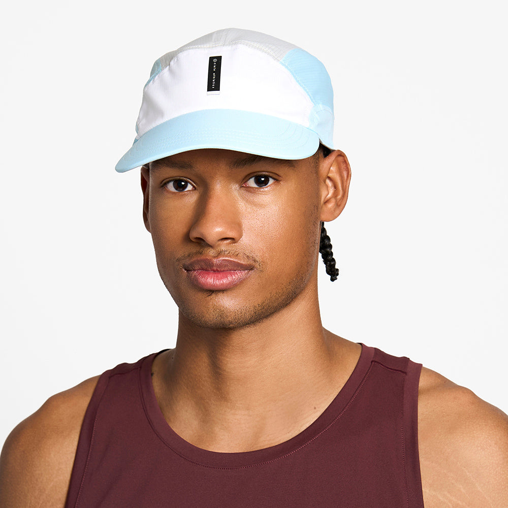 front view of the ciele athletics FTSCap unisex running hat with a curved brim in white color, on a model