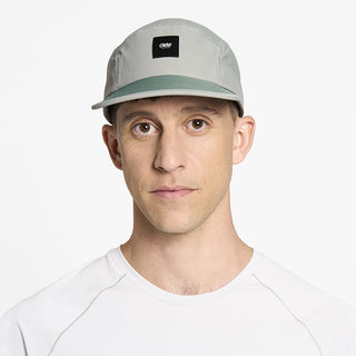 front view of ciele athletics GOCap EQ Frames unisex running hat in neutral grey color on a model