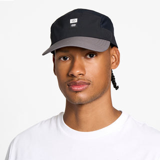 front view of the ciele athletics GOCap with a curved brim unisex running hat in whitaker color, on a model