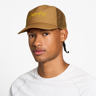 front view of the ciele athletics TRLCap unisex running hat with a curved brim in dark ochre color, on a model