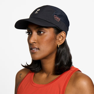 side view of ciele athletics GOCap SC Comp Word Wild Mouvement unisex running hat for the Paris marathon on a model