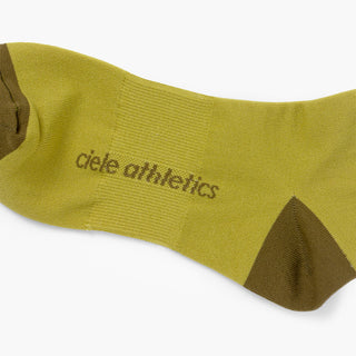 green sock with dark green accents and 'ciele athletics' branding on a white background