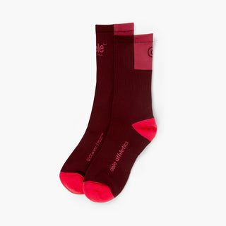 pair of brick color socks with red accents on a white background
