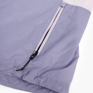 closeup view of the zippered side pocket of the ciele athletics VNTJacket lightweight running jacket for women in grape color